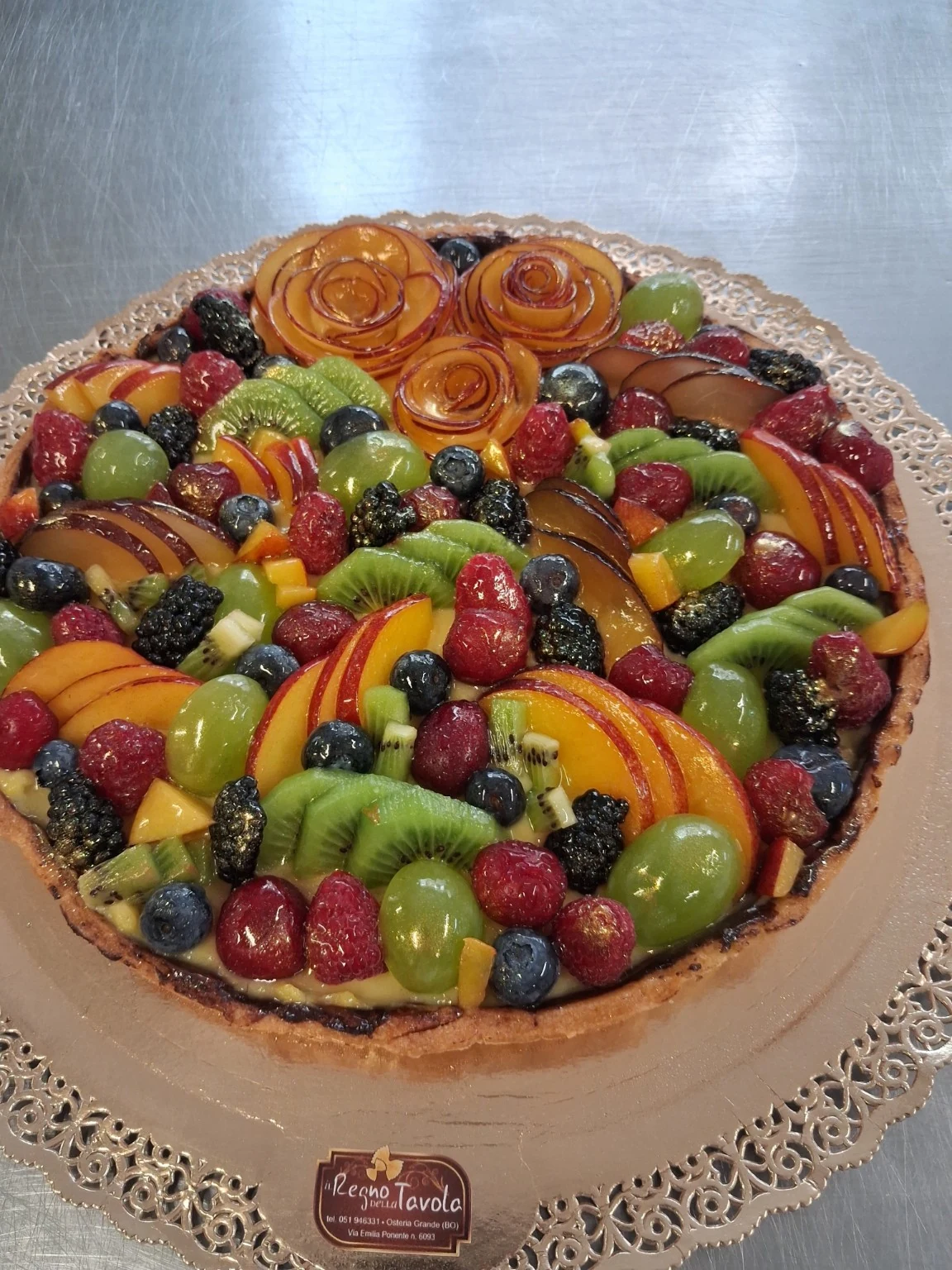 Crostata del laboratorio decorata con frutta e rose di frutta
